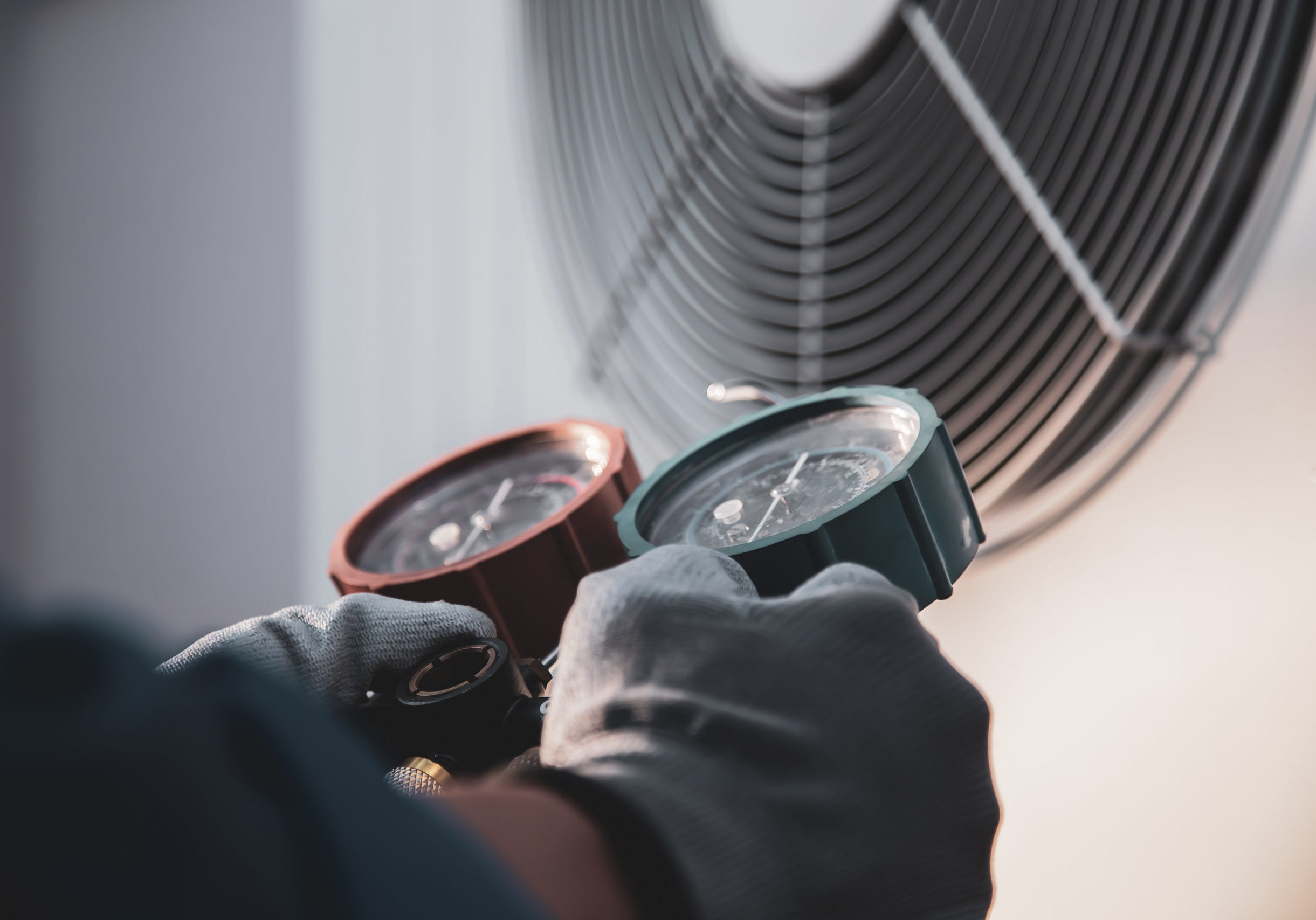 Heat and Air Conditioning, HVAC system service technician using measuring manifold gauge checking refrigerant and filling industrial air conditioner after duct cleaning maintenance outdoor compressor.